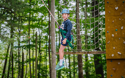camper on rope swing